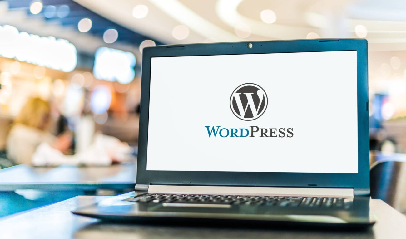 laptop computer displaying logo of wordpress